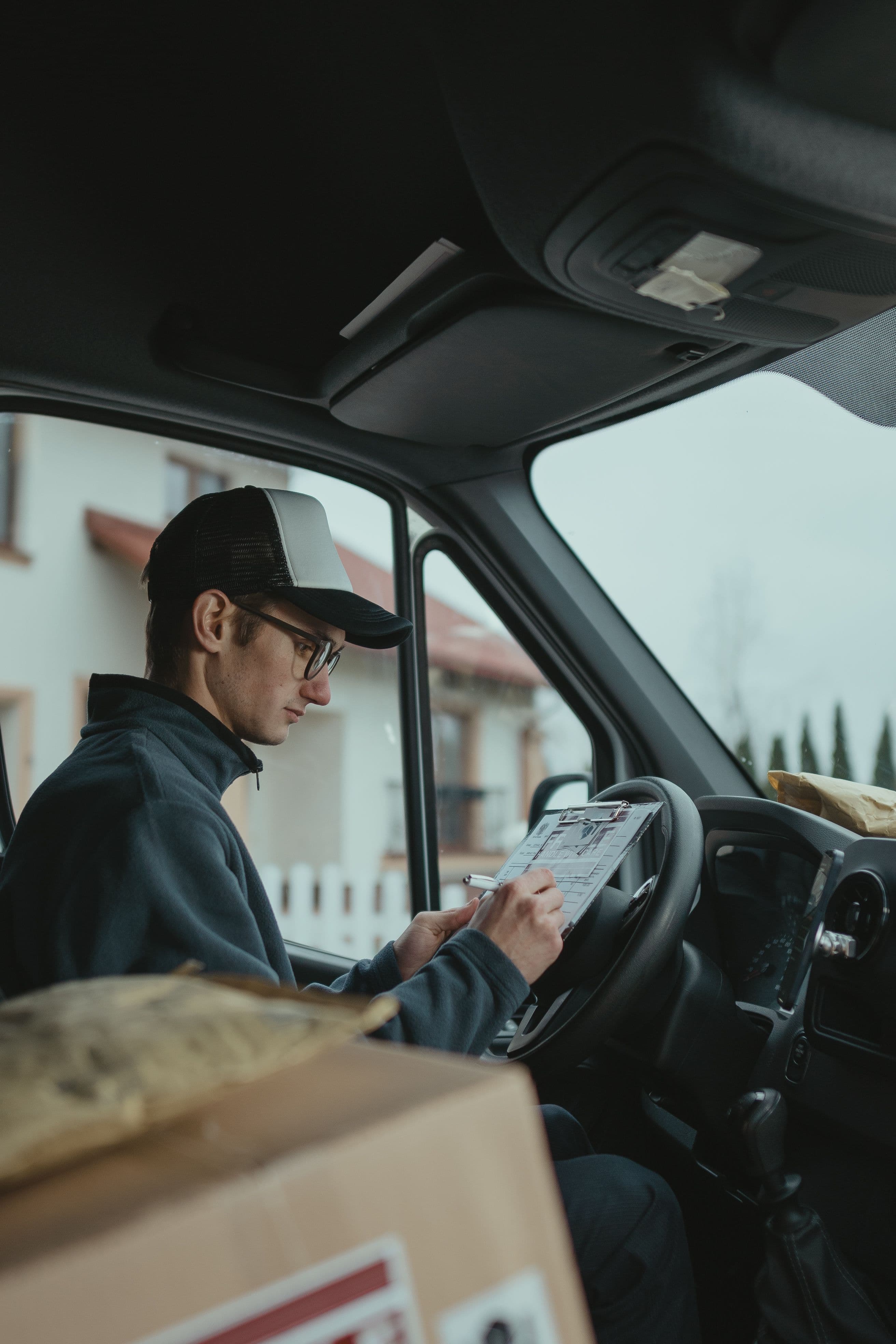 Trucker carefully reviewing paperwork before accepting load